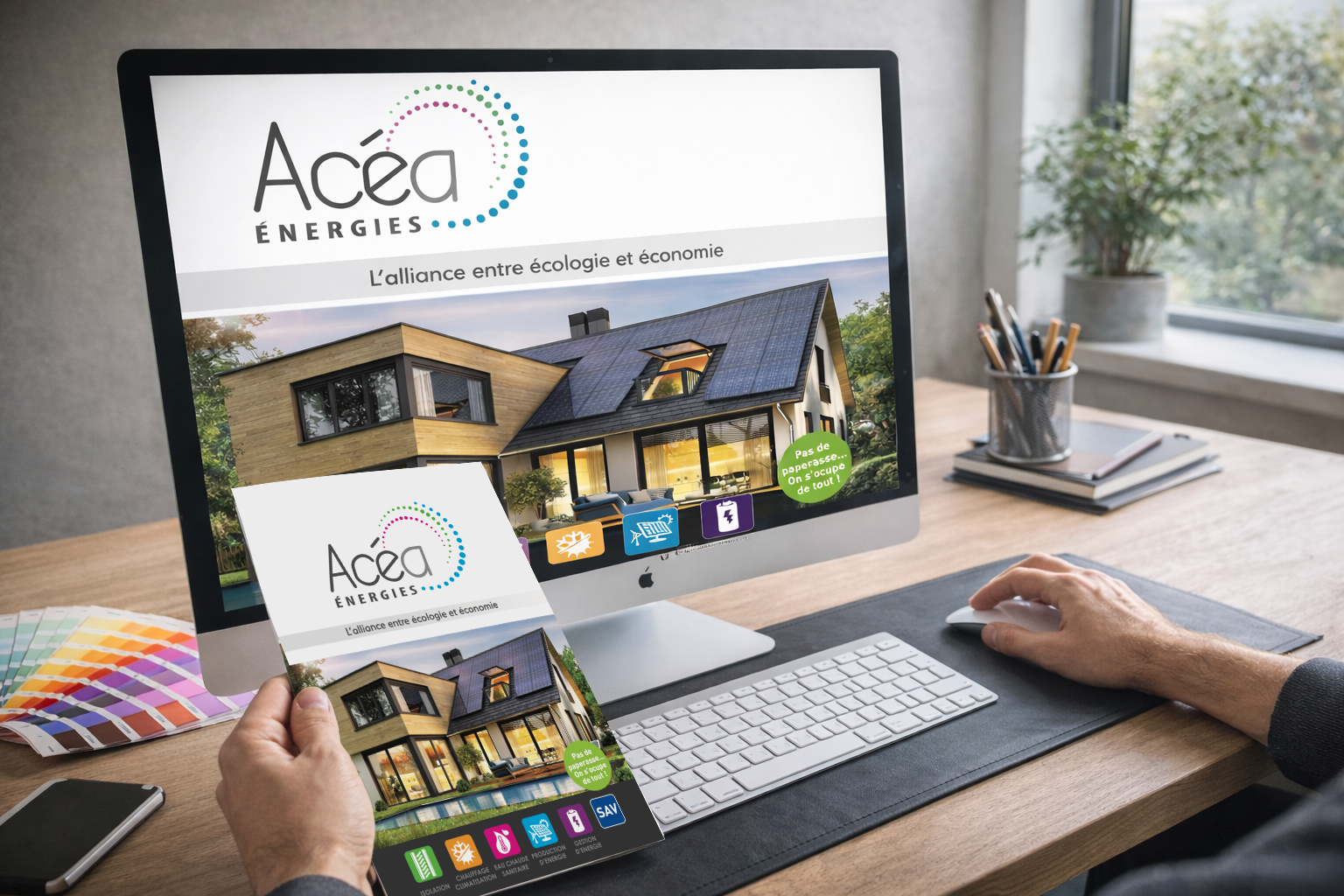 Graphiste au bureau travaillant sur un projet de communication, avec plaquette imprimée et visuel à l’écran, création graphique print et digitale à Sérignan